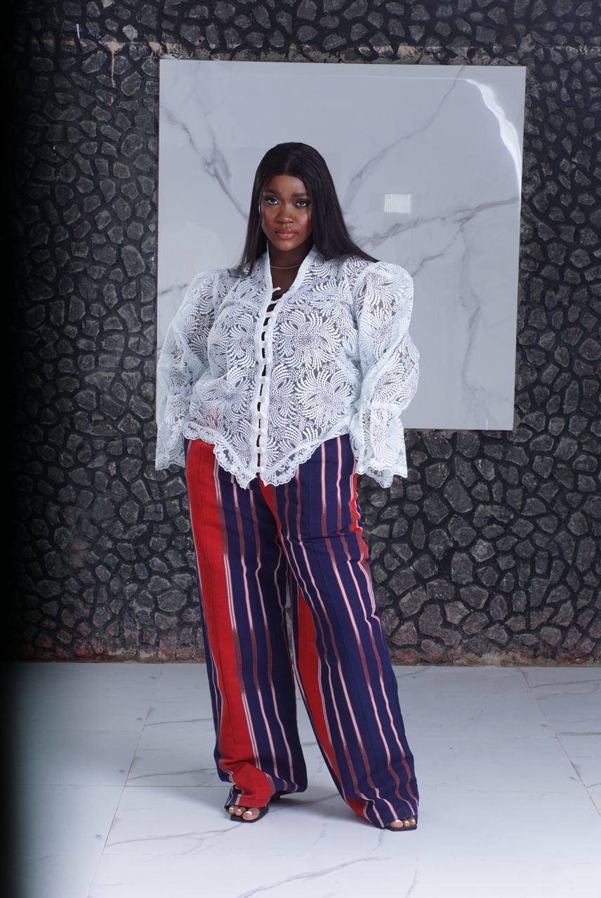 owambe two piece styles for ladies showing a woman wearing aso-oke owambe two piece called Dania made by Ahdookeh Fashion