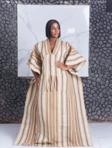 where to buy bubu gowns in lagos showing a woman wearing a bubu gown crafted and made by Ahdookeh Fashion